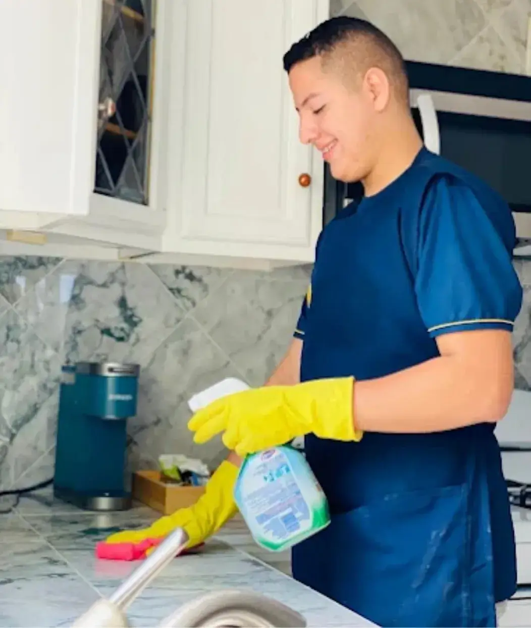 Cleaning technician from Agnus Dei Cleaning Services sanitizing kitchen surfaces in Connecticut home